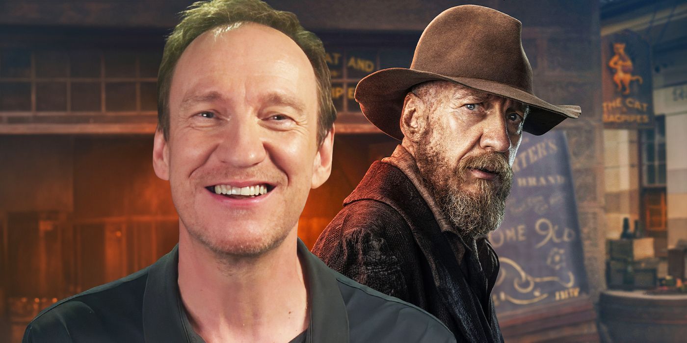 David Thewlis at The Artful Dodger press day junket, smiling. In the background is an image of him as Fagin. 