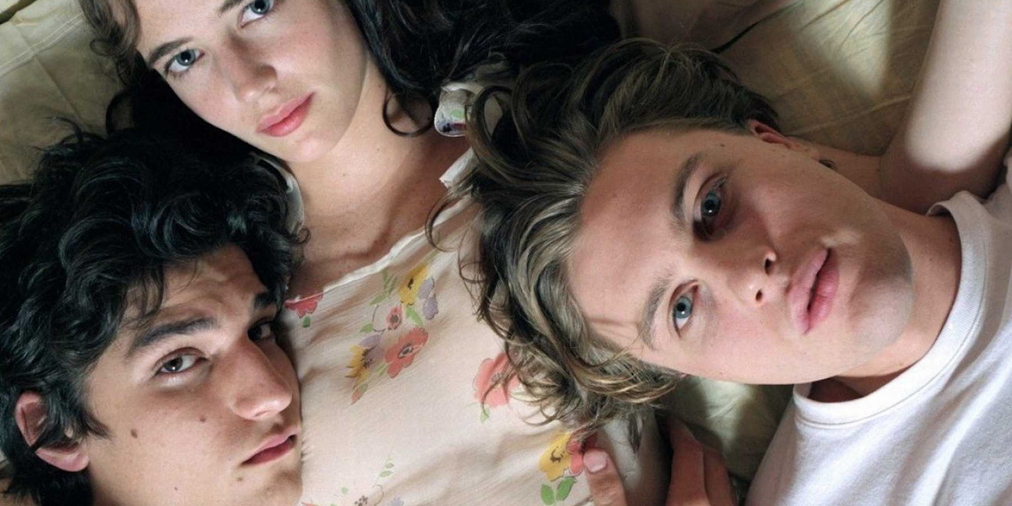 Michael Pitt, Eva Green, and Louis Garrel looking at the camera in The Dreamers