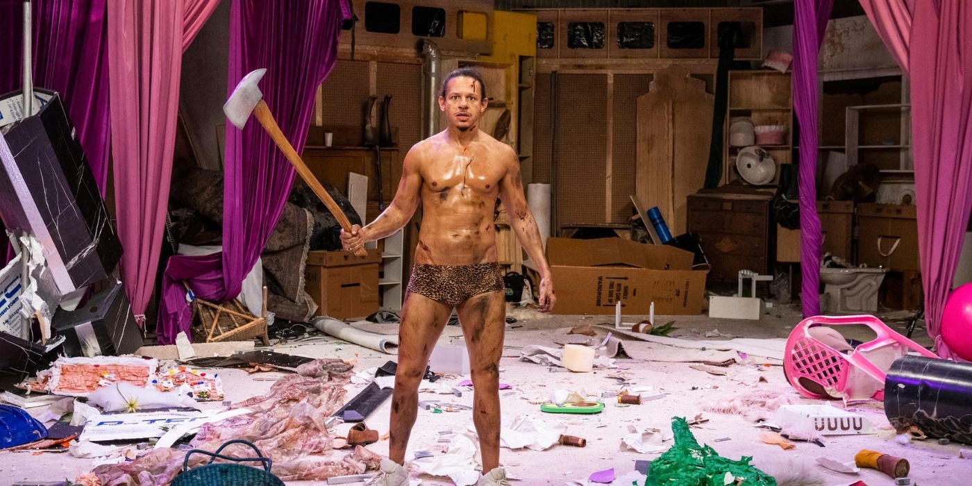 Eric Andre, holding an axe and wearing leopard print underwear 