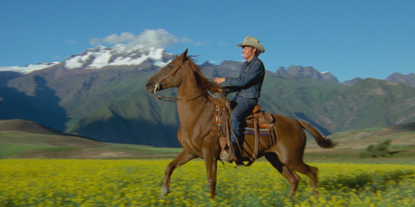 Dennis Hopper riding a horse through an open field in The Last Movie.
