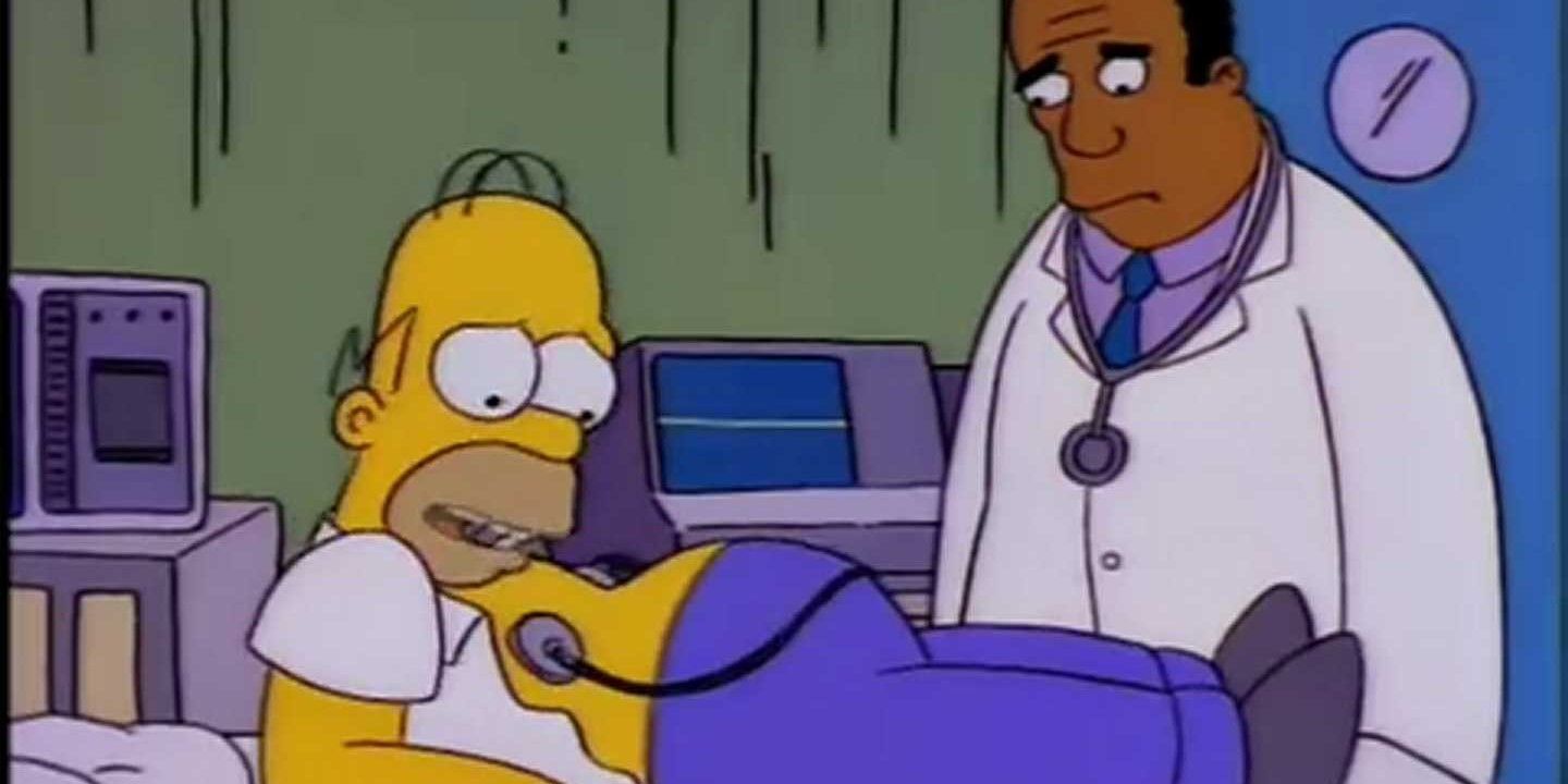 Homer lies in a hospital with a monitor connected to his chest and a doctor standing nearby in The SImpsons.