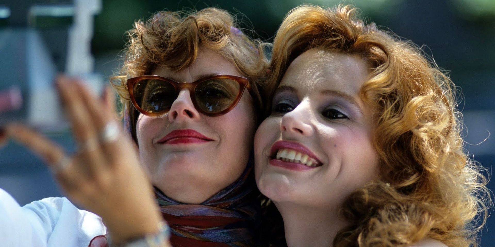 Louise and Thelma posing for a Polaroid selfie and smiling in 'Thelma & Louise' (1991)