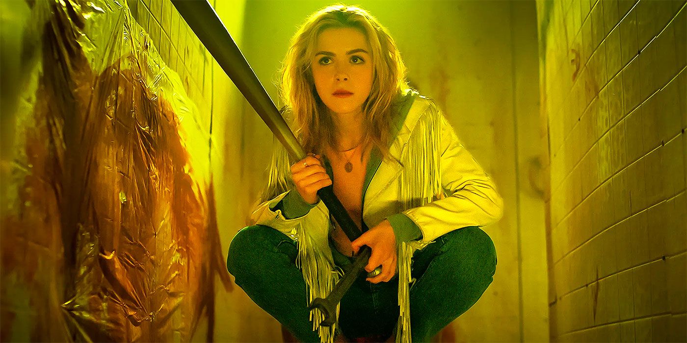 Kiernan Shipka as Jamie Hughes holding a bat and hiding in a bloody stall in Totally Killer