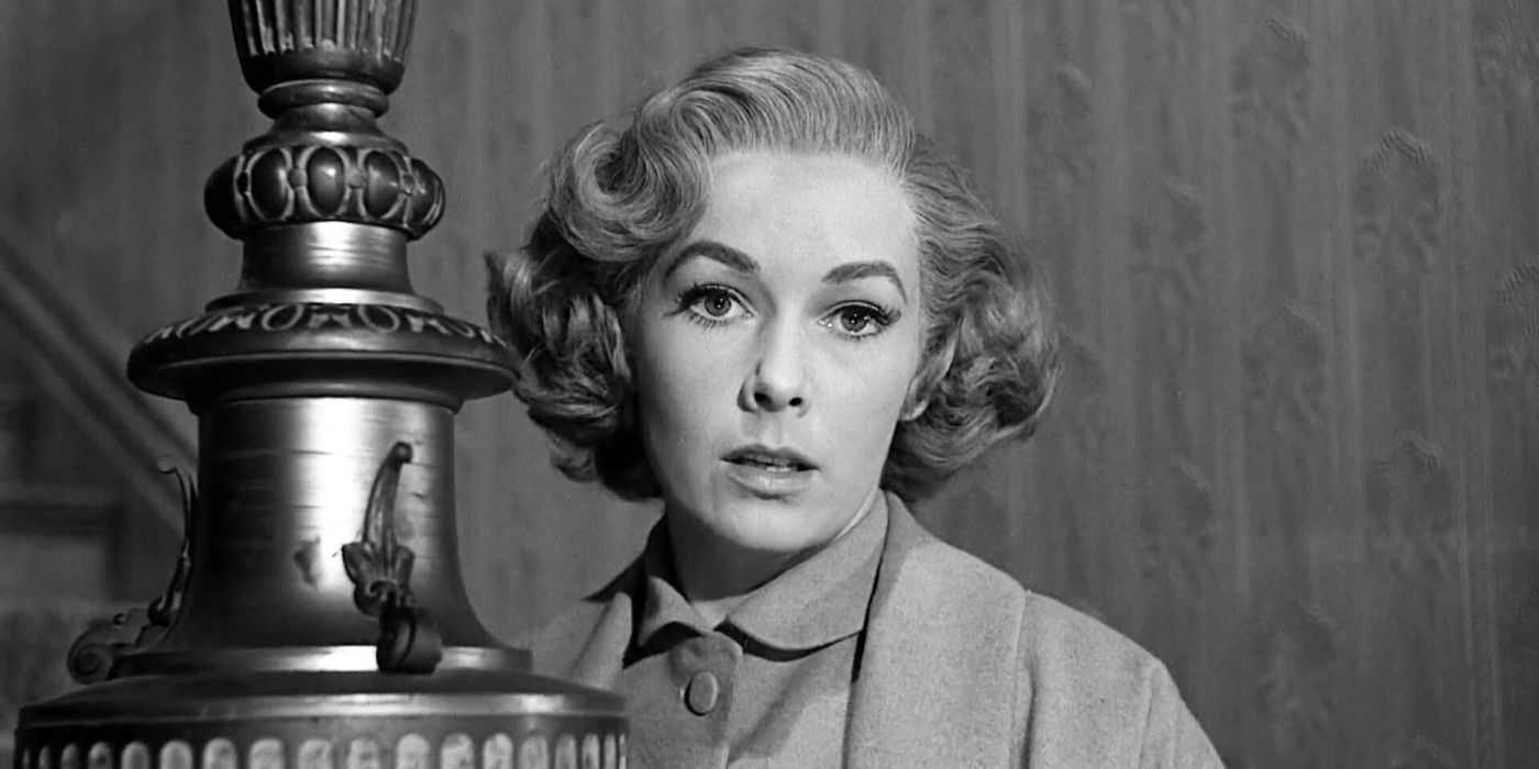Vera Miles standing at the bottom of a staircase in Psycho (1960)