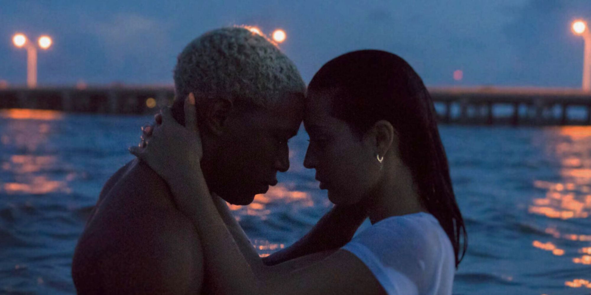 Tyler puts his head against his girlfriend, Alexis, standing in the ocean in Waves.