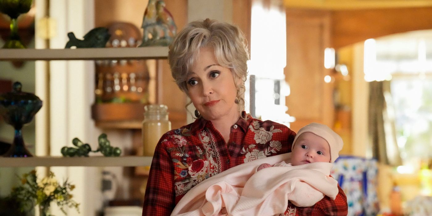 Meemaw (Annie Potts) holding a baby in Young Sheldon