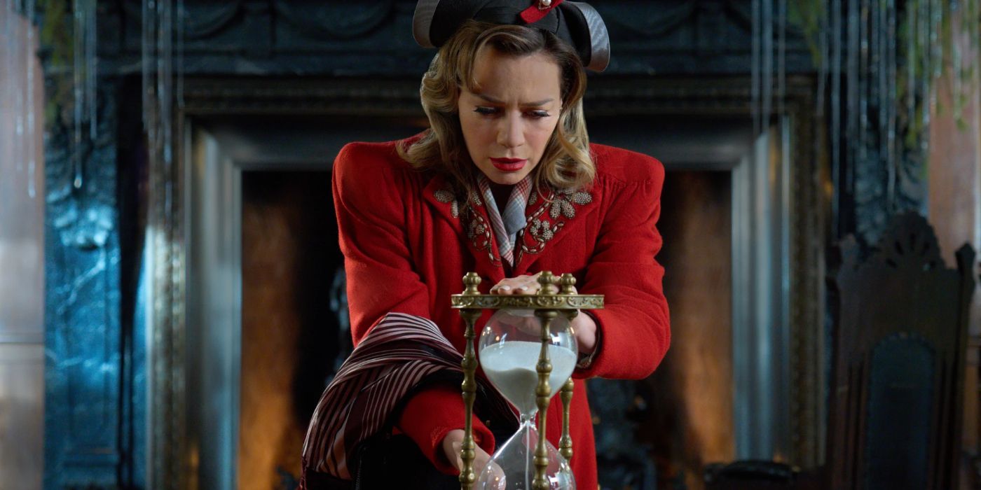 A concerned Lucy, played by Bethany Joy Lutz, holding onto a magical hourglass while wearing 1940s clothing in Hallmark's A BIltmore Christmas