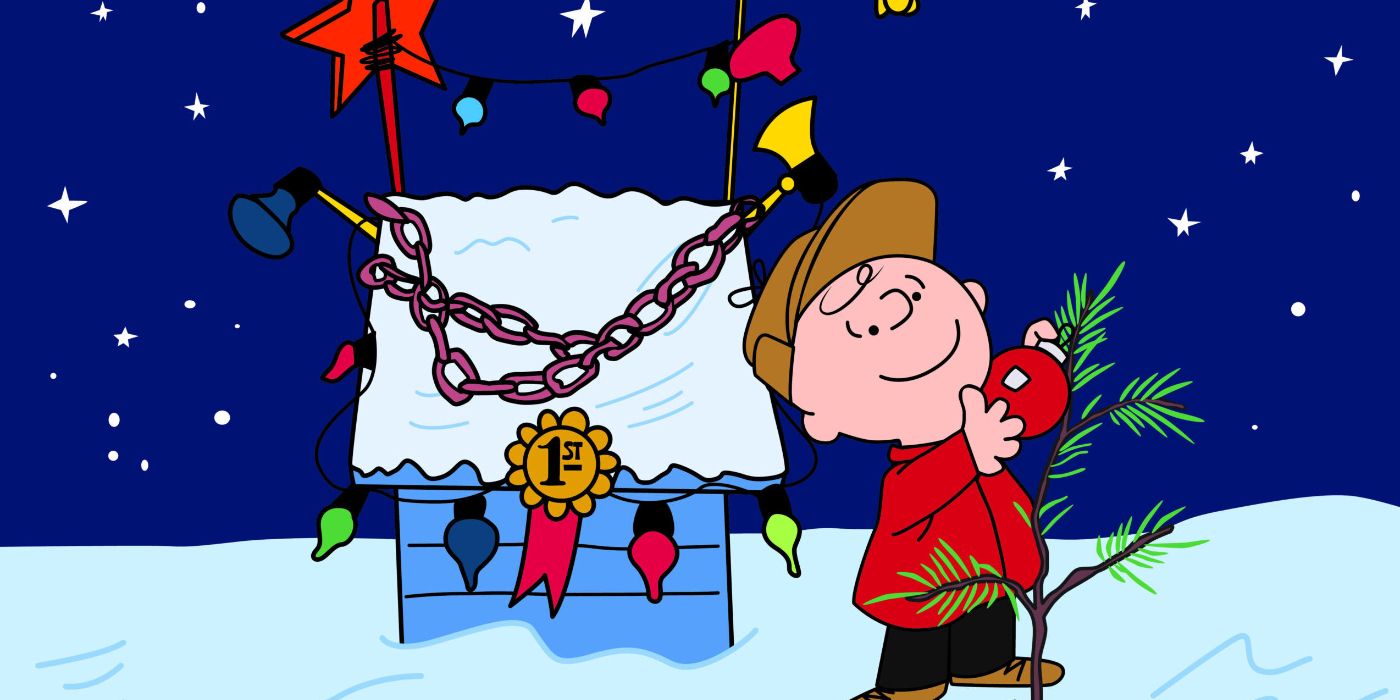A smiling Charlie Brown hanging one red ornament on the little tree in A Charlie Brown Christmas