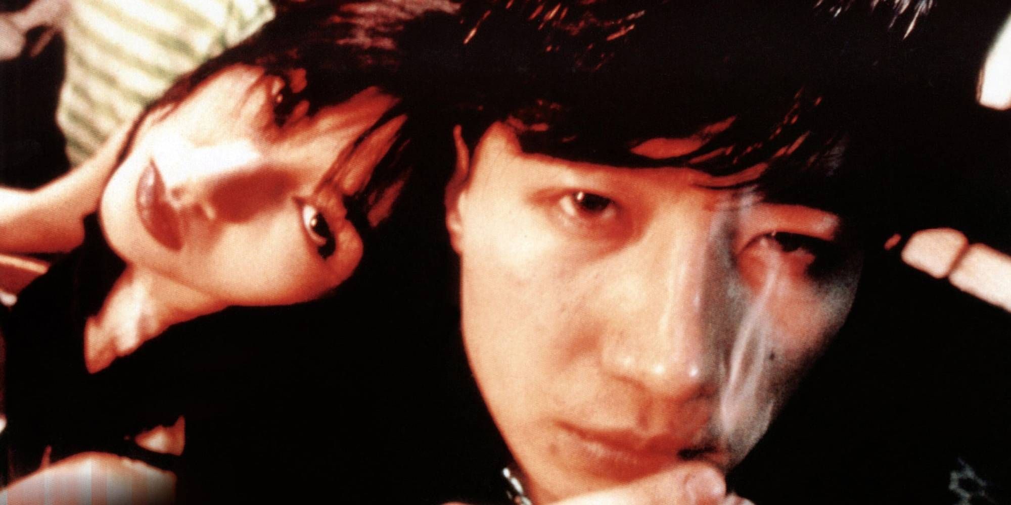 A close-up shot of Michelle Monique Reis and Takeshi Kaneshiro looking at the camera in Fallen Angels