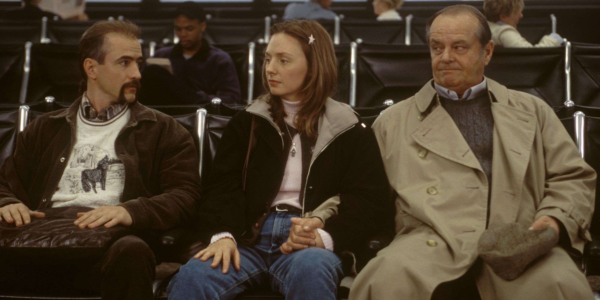 Jack Nicholson, Dermot Mulroney, and Hope Davis sitting in an airport terminal in About Schmidt