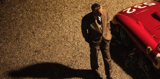 Adam Driver as Enzo Ferrari walking in Ferrari movie