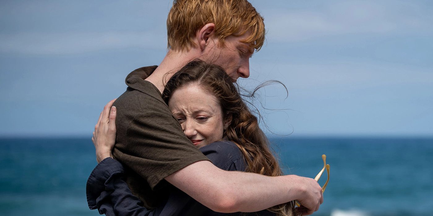 Domhnall Gleeson and Andrea Riseborough hugging on a beach in Alice and Jack