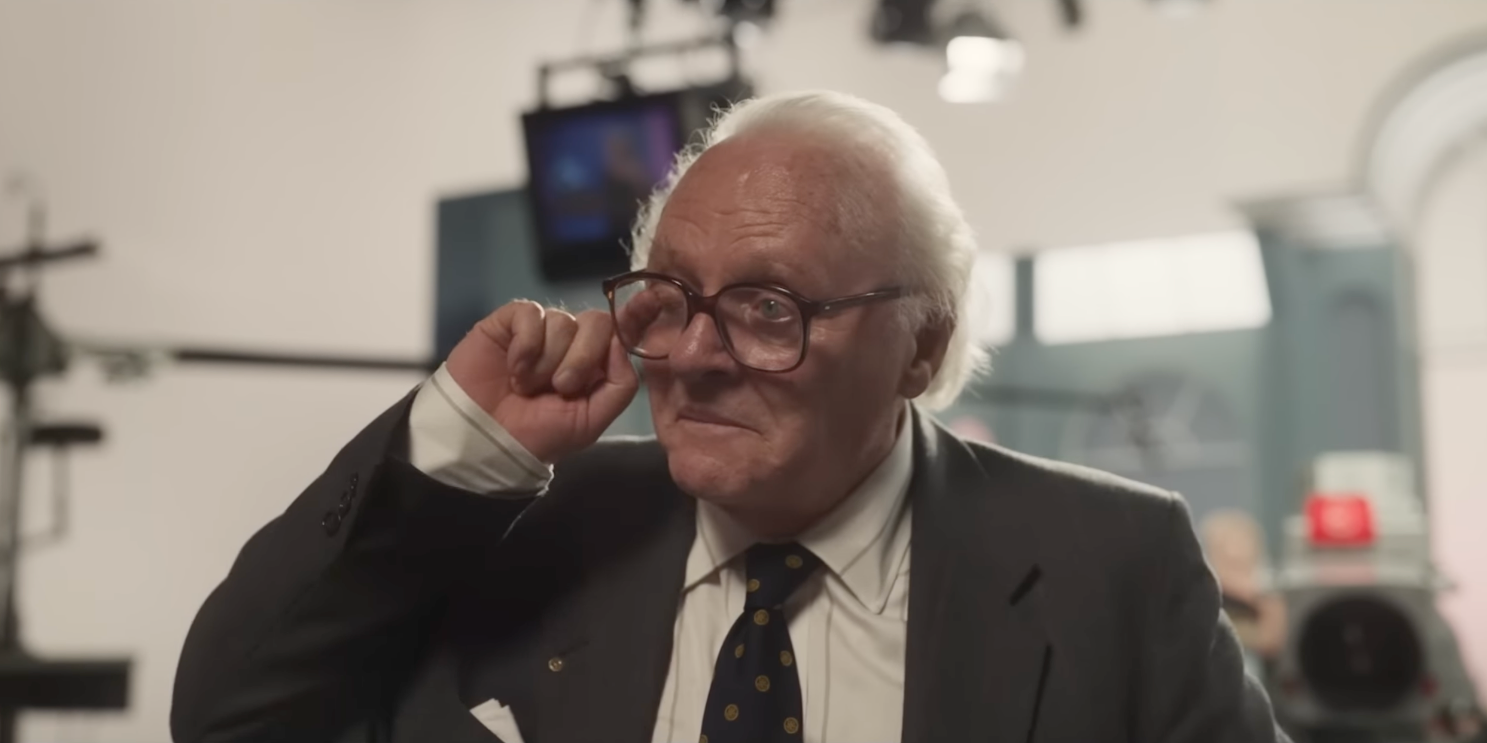 Anthony Hopkins as Nicholas Winton wiping tears from behind his glasses