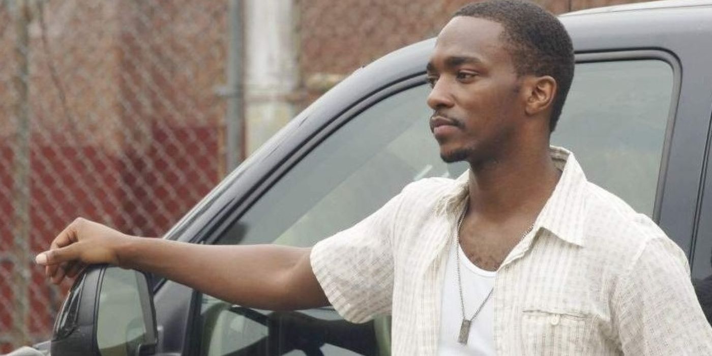 Anthony Mackie as Frank standing beside his car looking ahead in Half Nelson
