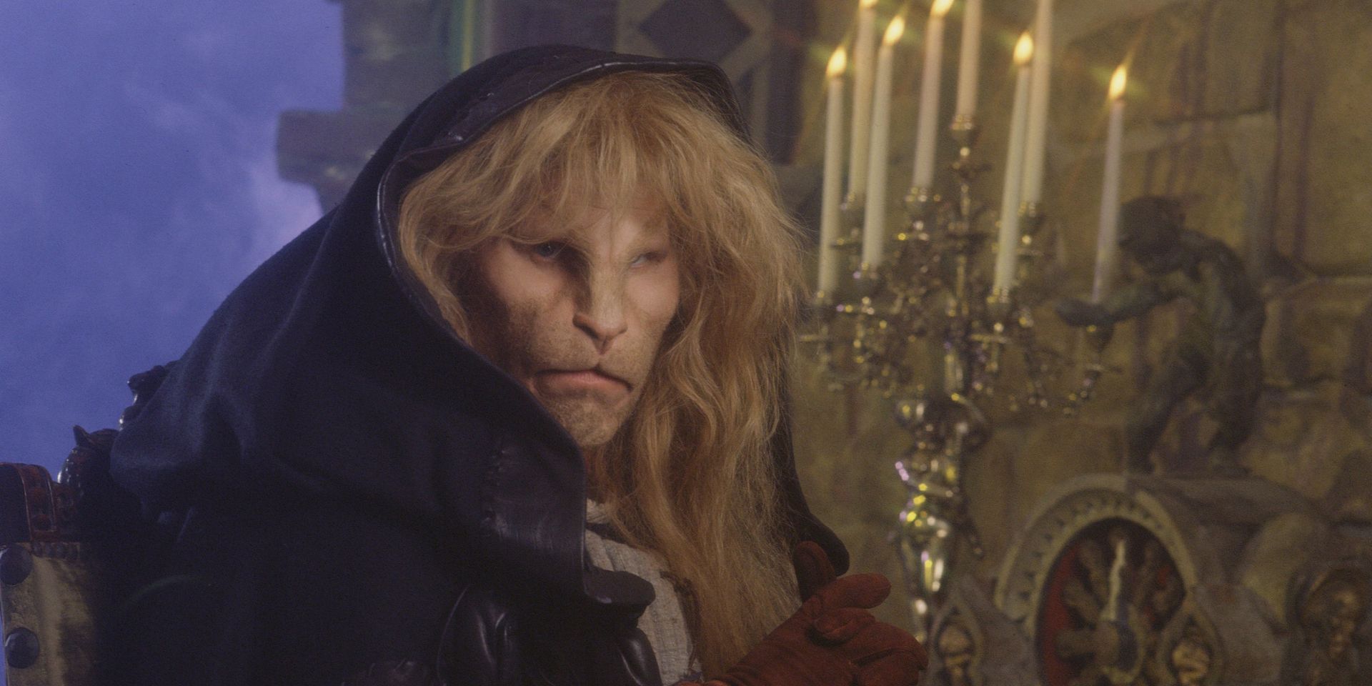 Ron Perlman's Vincent Staring Ahead Holding a Candelabra while Cloaked in a Hood in Beauty and the Beast