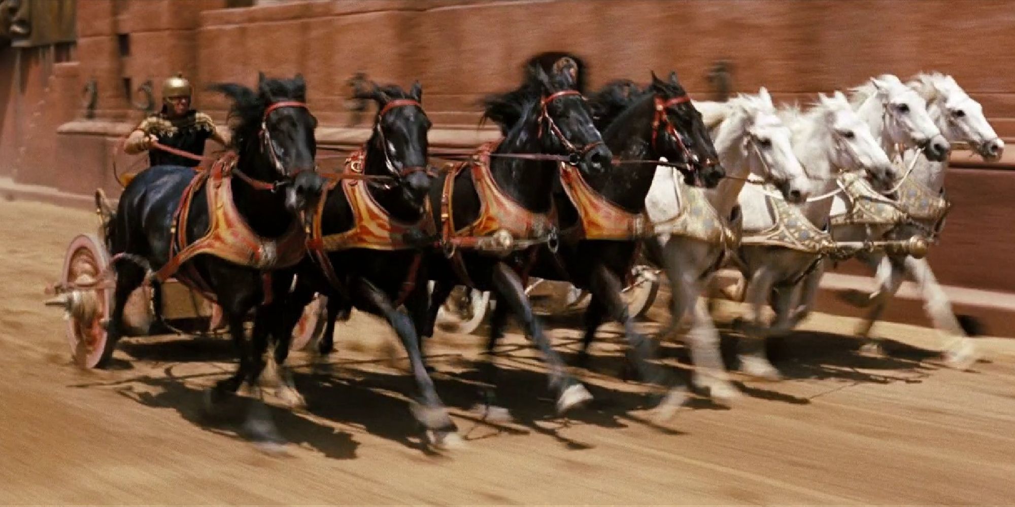 A man races a chariot pulled by eight horses in Ben-Hur