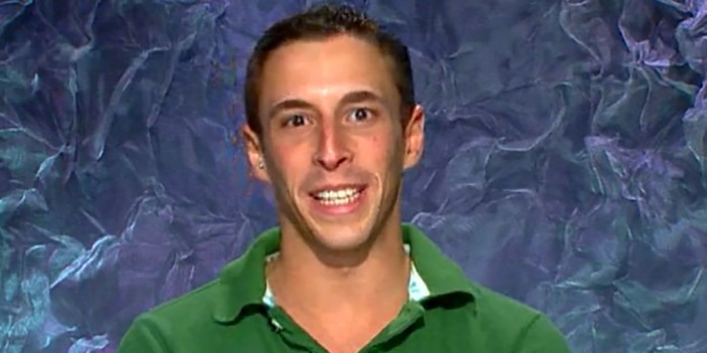 A close up of Eric Stein in the diary room on Big Brother, smiling.