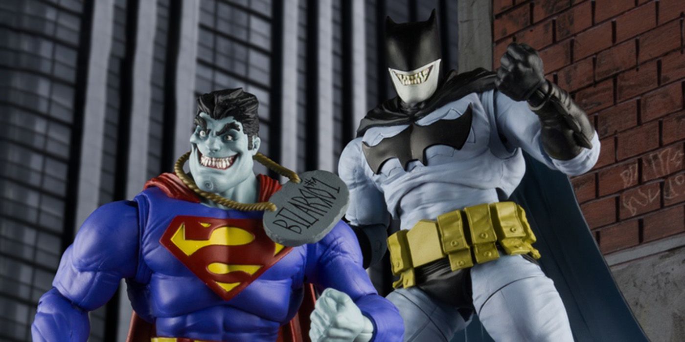 Action figures of Bizarro Superman and Batzarro Batman against a city scape background