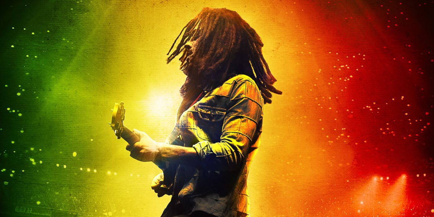 Bob Marley (Kingsley Ben-Adir) playing the guitar in a stadium on the poster for Bob Marley: One Love