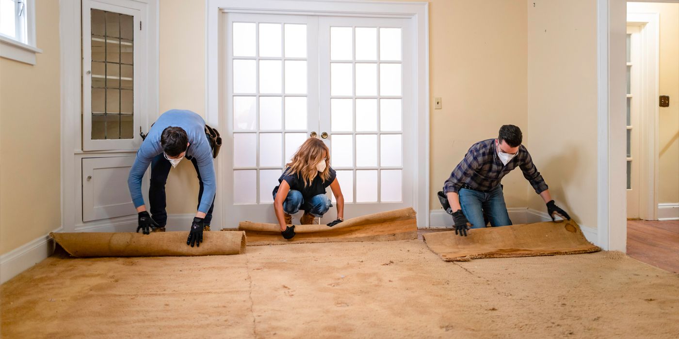 Halle Berry and the Property Brothers lay out carpet for a home renovation in Celebrity IOU Season 4.