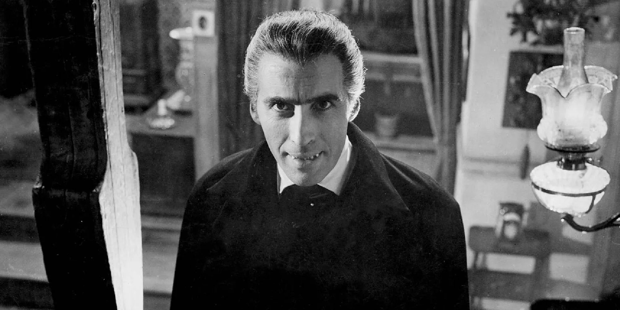 A black and white shot of Christopher Lee as a vampire looking at the camera in Dracula.
