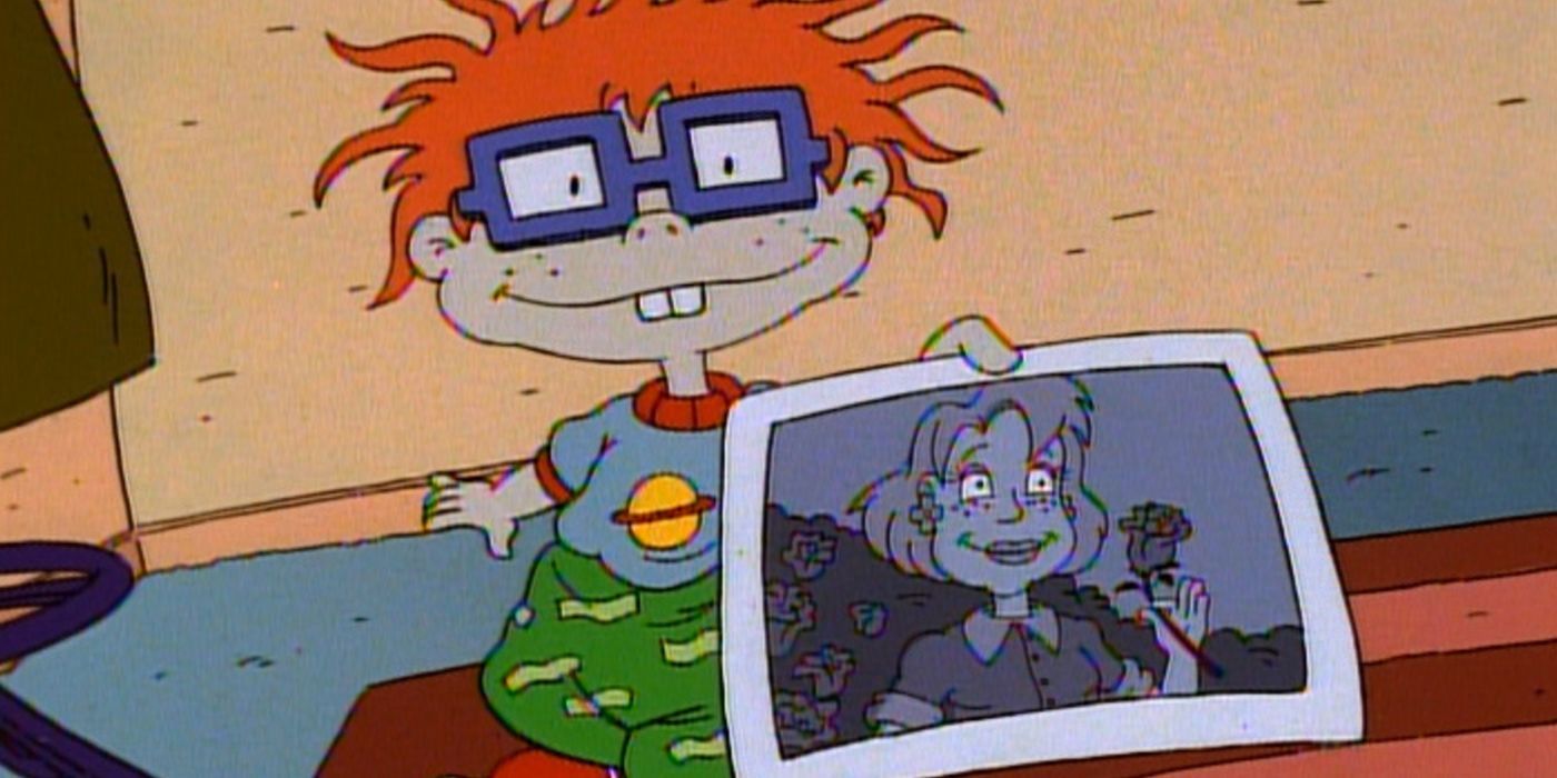 Chuckie showing a picture of his mom and smiling in Rugrats