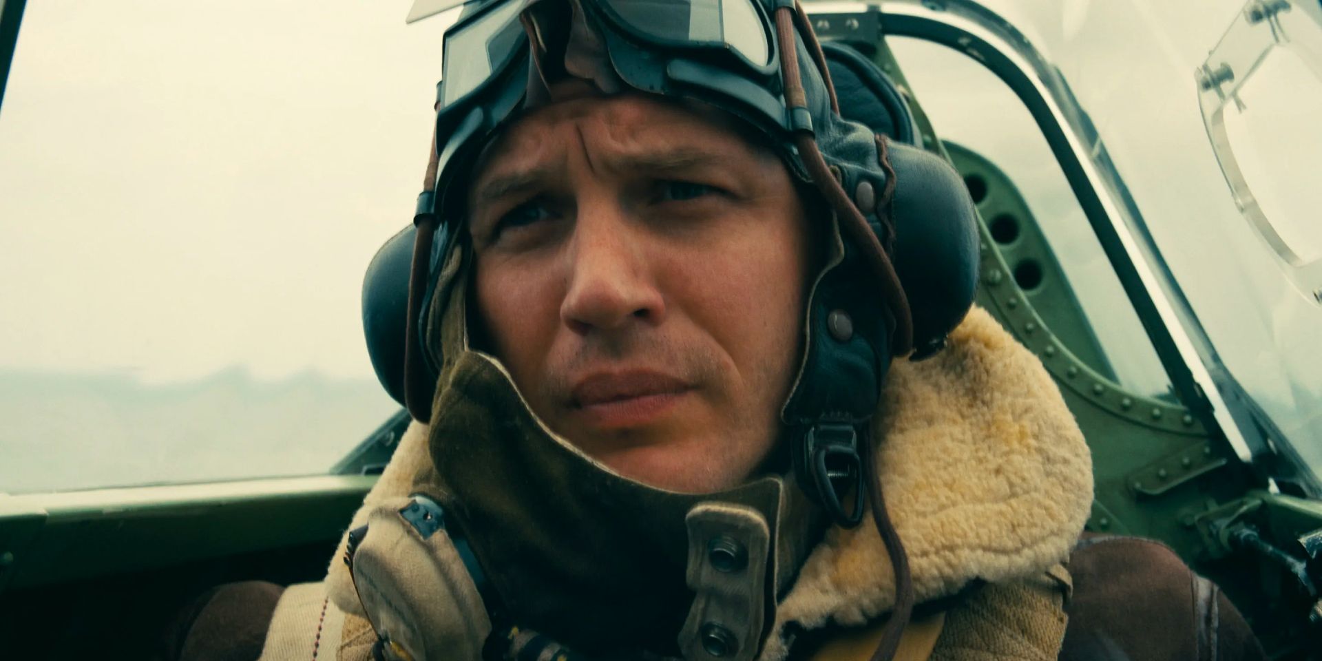 An English pilot in the cockpit of a Spitfire flying over Dunkirk.