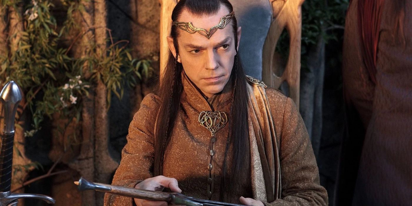 Elrond sitting down and holding a sword in The Lord of the Rings