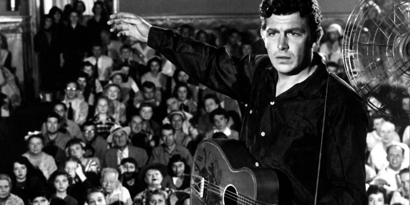 Andy Griffith performs with a guitar for a large crowd as Larry in A Face in the Crowd
