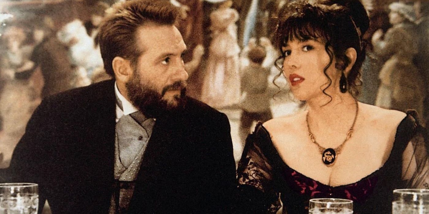 Gérard Depardieu and Isabelle Adjani as Auguste Rodin and Camille Claudel talking while at a dinner party in the film Camille Claudel