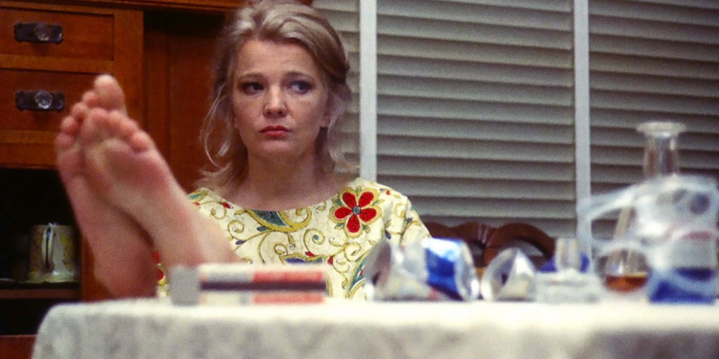 Gena Rowlands as Mabel Longhetti looking sad with her feet up on a table in the film A Woman Under the Influence