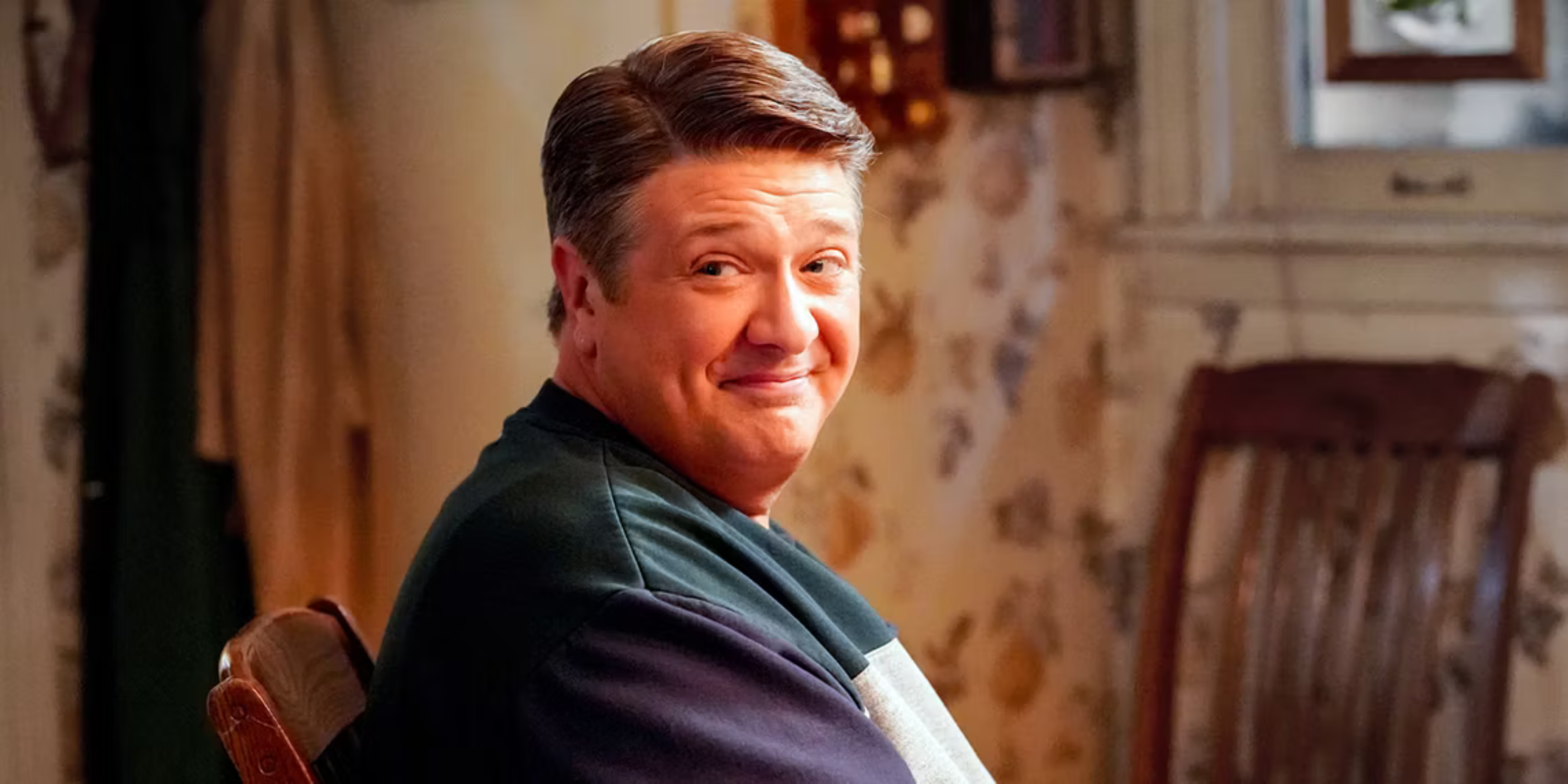 Lance Barber as George Cooper looking at a person offscreen in Young Sheldon