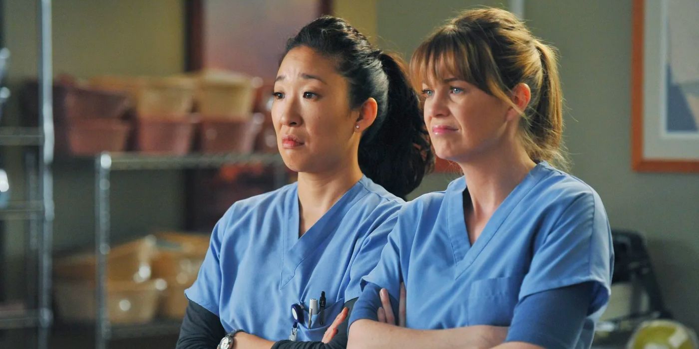 Sandra Oh as Cristina Yang & Ellen Pompeo as Meredith Grey with their arms crossed in Grey's Anatomy