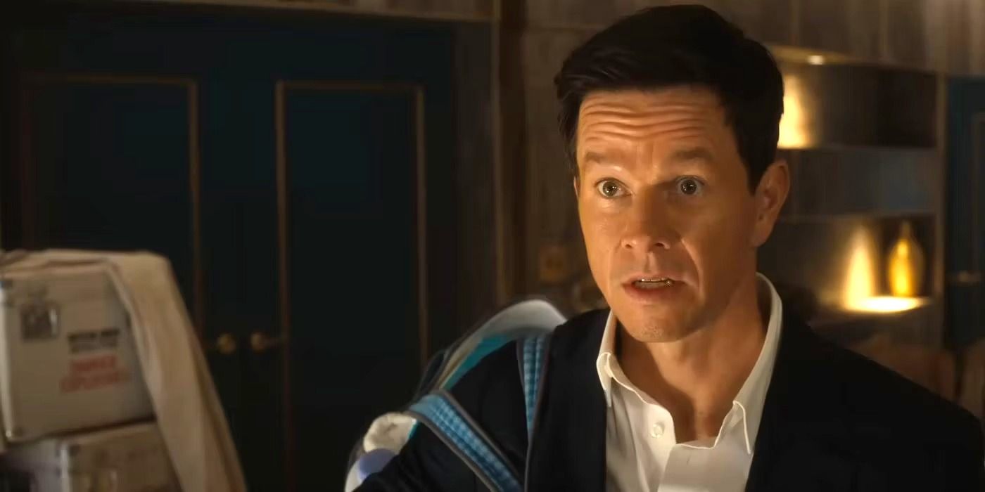 Mark Wahlberg looking concerned while surrounded by boxes as Dan Morgan in The Family Plan