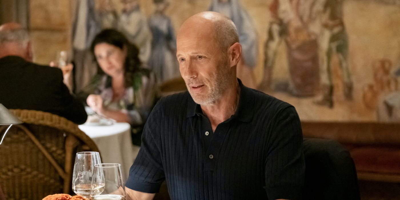 Greg (Jon Gries) sitting at a restaurant in The White Lotus Season 2.