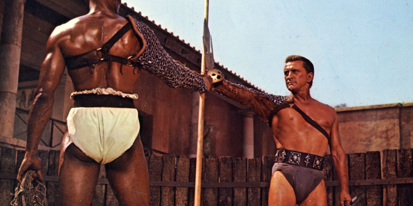 Kirk Douglas reaching for a spear in Spartacus