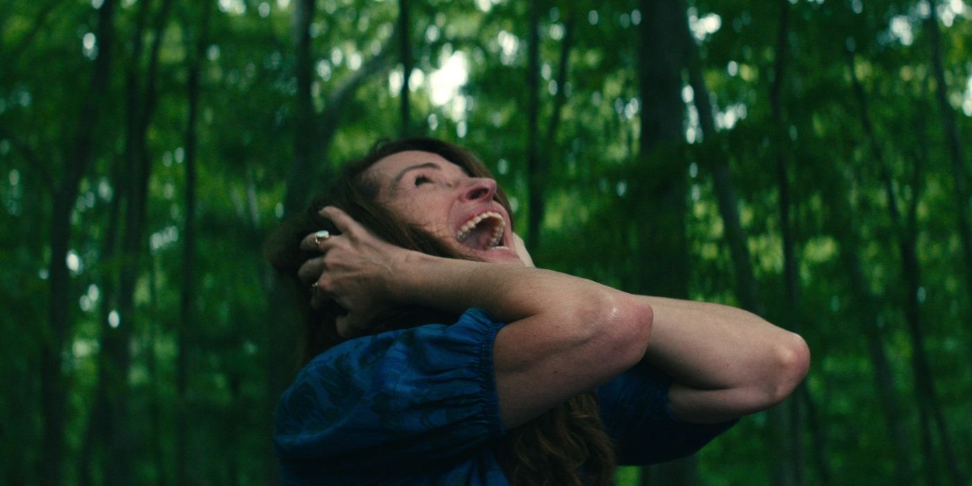 Julia Roberts as Amanda screaming and covering her ears while in a forest in Leave the World Behind