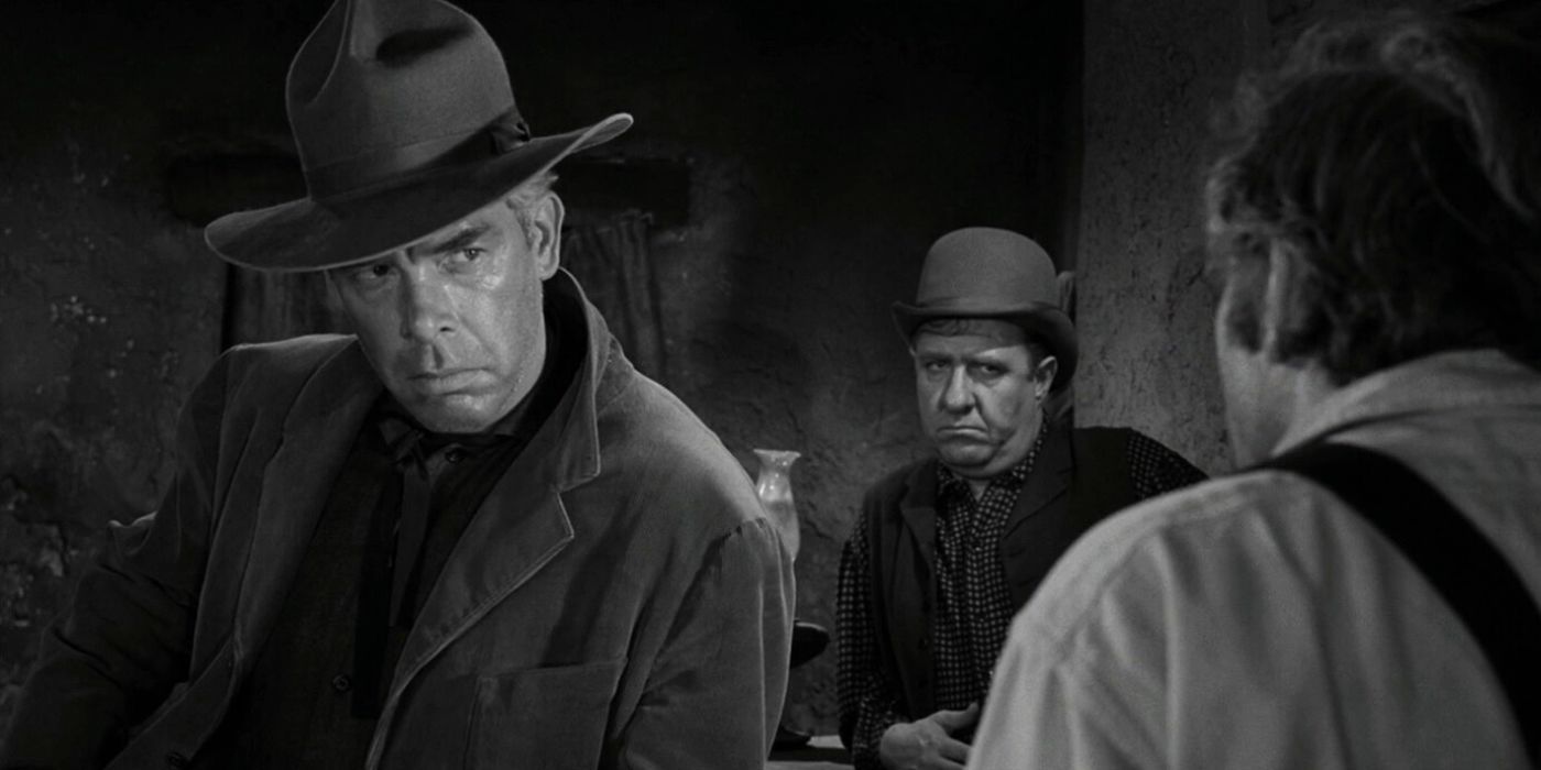 Lee Marvin leaning against a bar looking at someone in The Twilight Zone