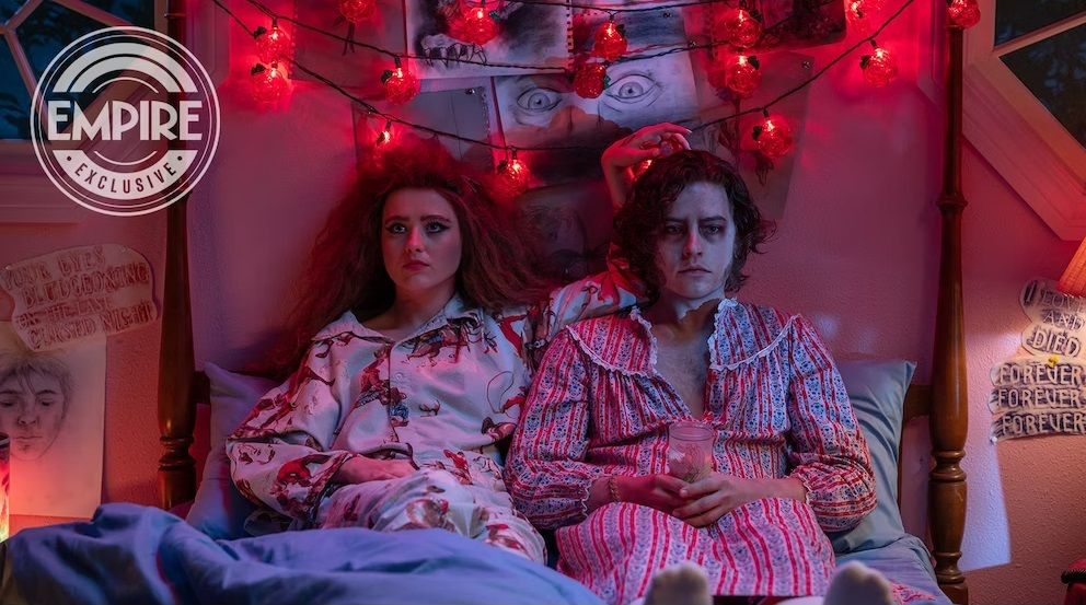 Lisa, played by Kathryn Newton, sits on a bed with her undead boyfriend played by Cole Sprouse 