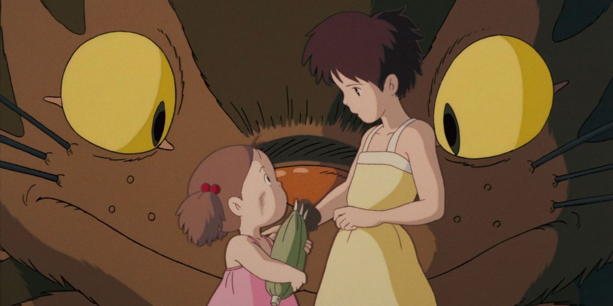 Mei Kusakabe and Satsuki talking while a giant cat-like creature stands behind them in My Neighbor Totoro