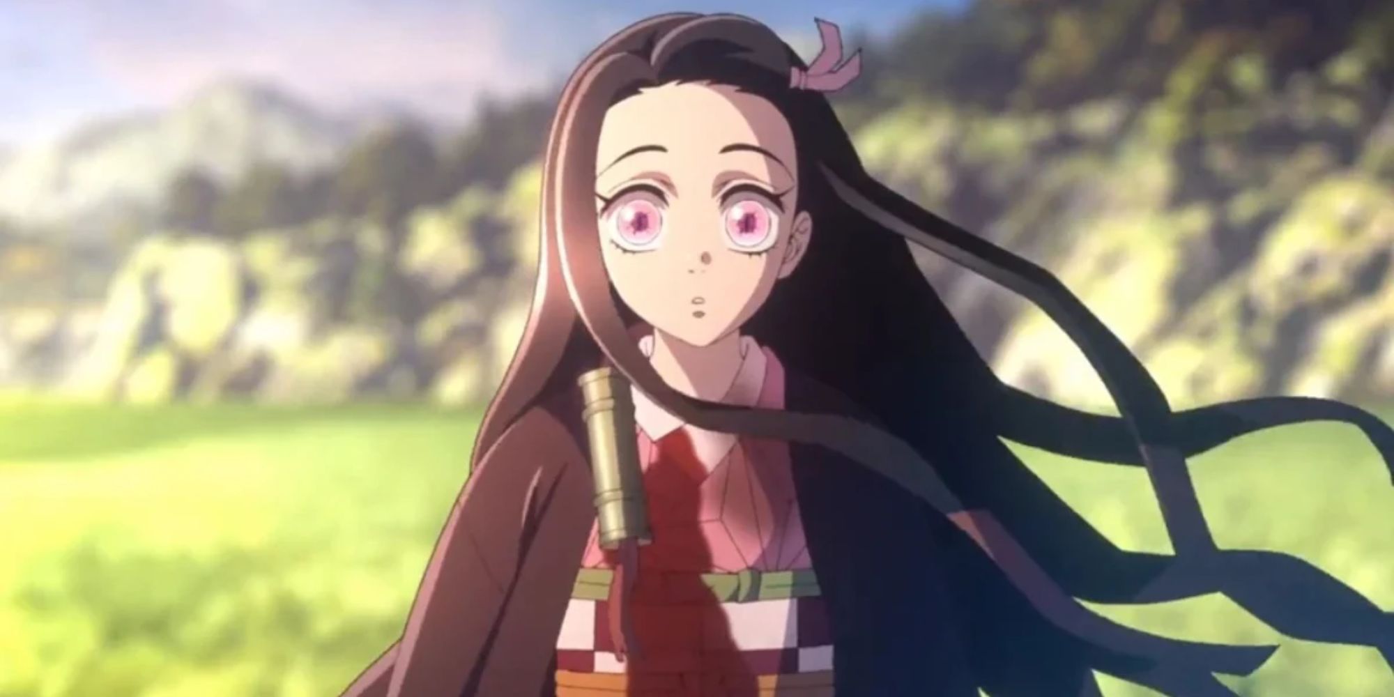 Nezuko from Demon Slayer wide-eyed and looking ahead while standing outside.