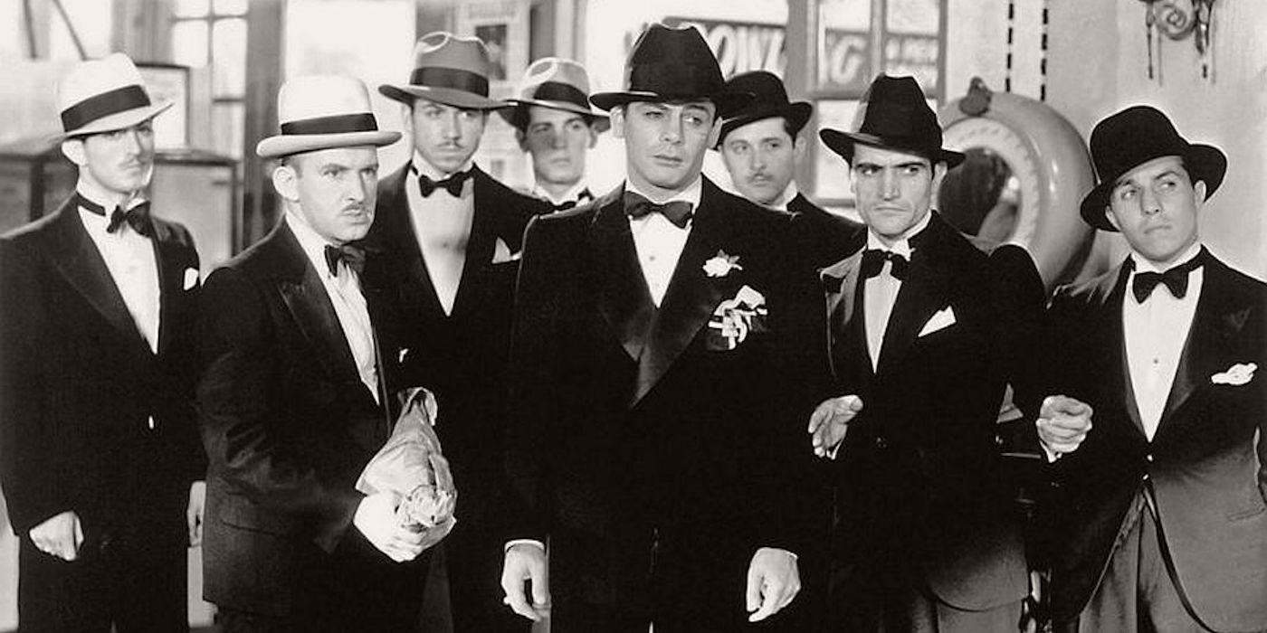 Paul Muni and a group of men in tuxedos in Scarface 1932