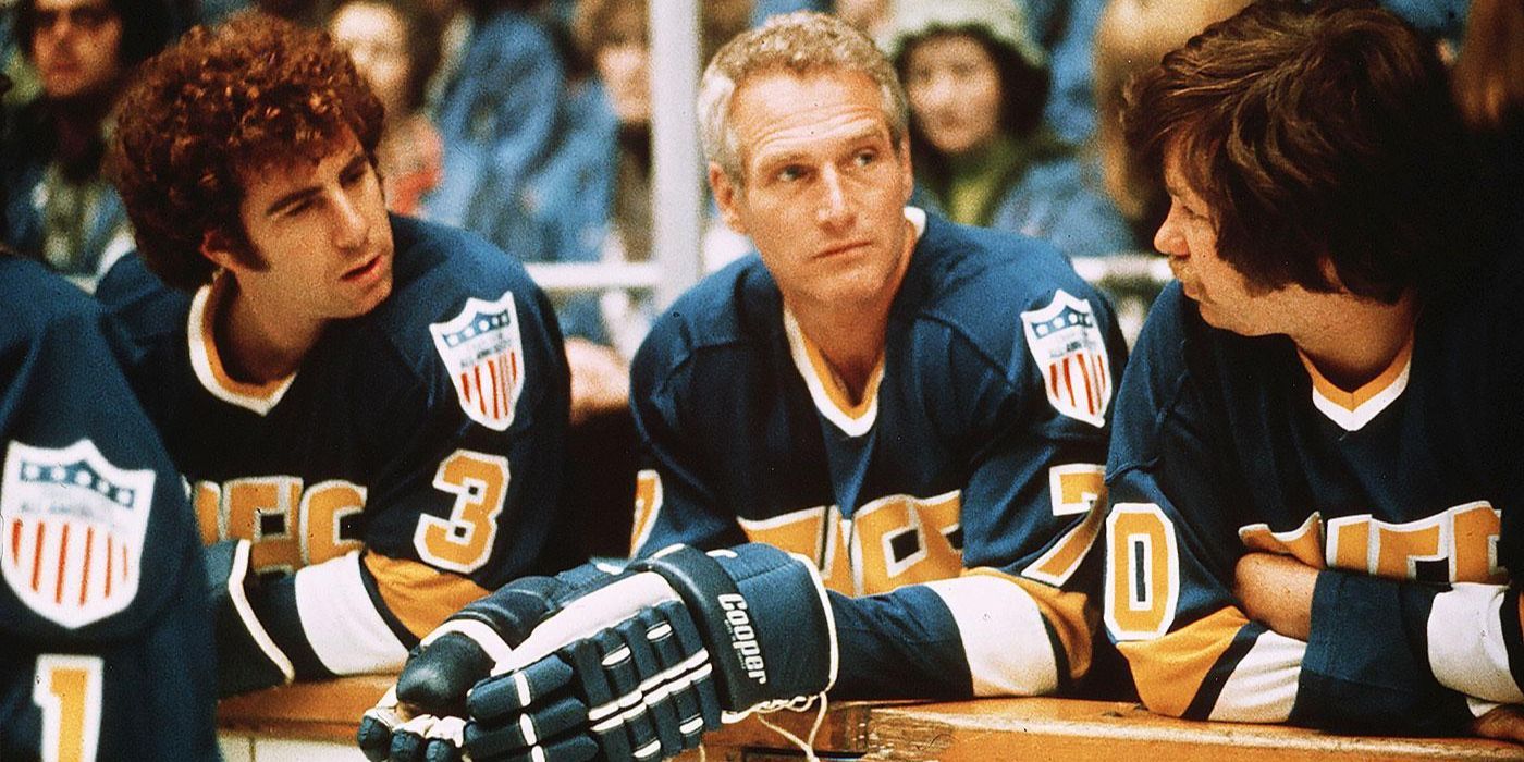 Paul Newman as Reggie Dunlop nxt to other hockey players in Slap Shot