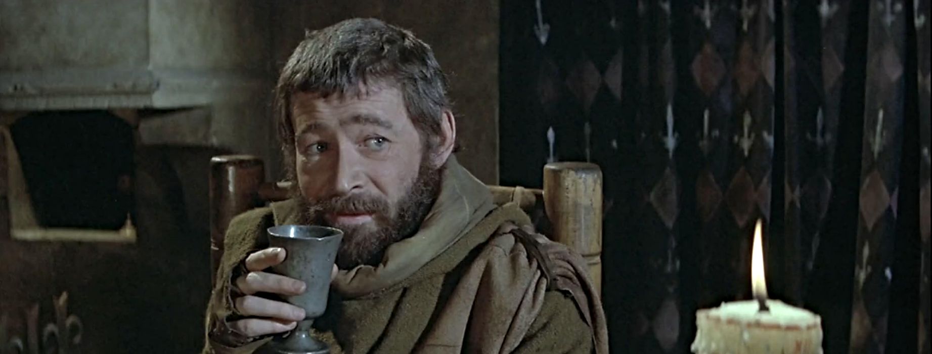 Peter O'Toole as Henry II looking snarky and drinking in The Lion in Winter