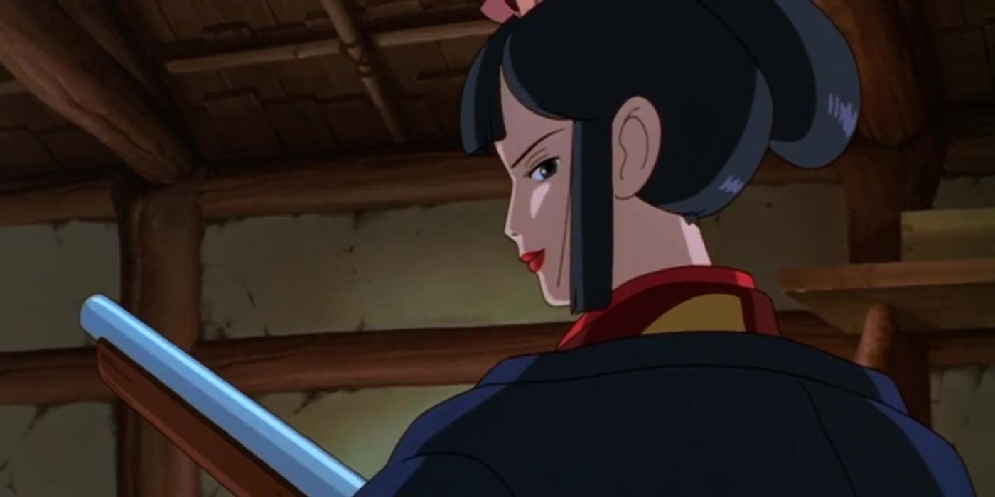 Lady Eboshi with one of her rifles turning around and smiling confidently in Princess Mononoke.