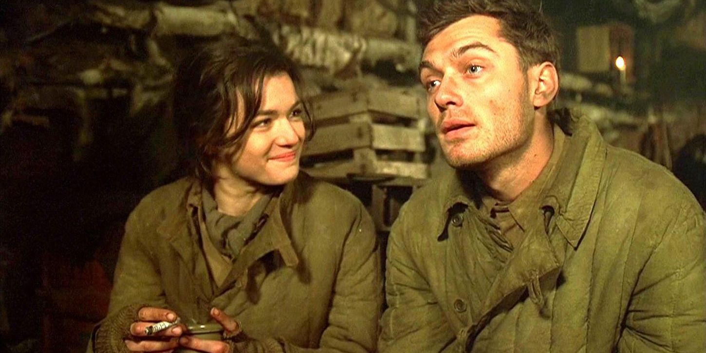 Rachel Weisz as Tania smiles at Jude Law as Vassili in a bunker in Enemy at the Gates.