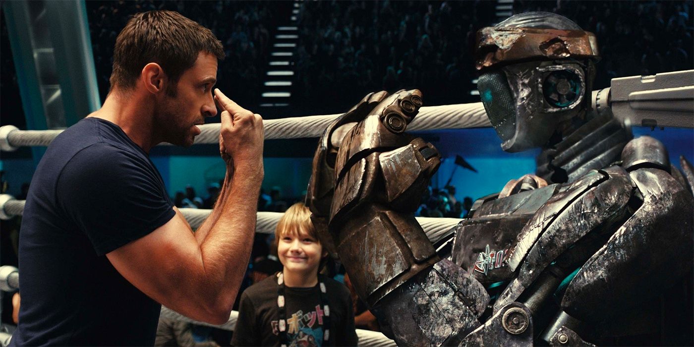 Charlie and Max Kenton in Real Steel training with a robot.