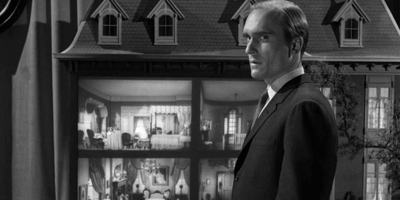 Robert Duvall standing in front of a doll house in The Twilight Zone