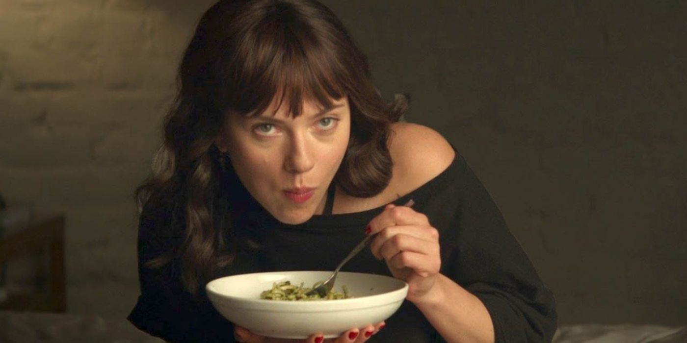 Scarlett Johansson as Molly eating while looking up at someone in Chef