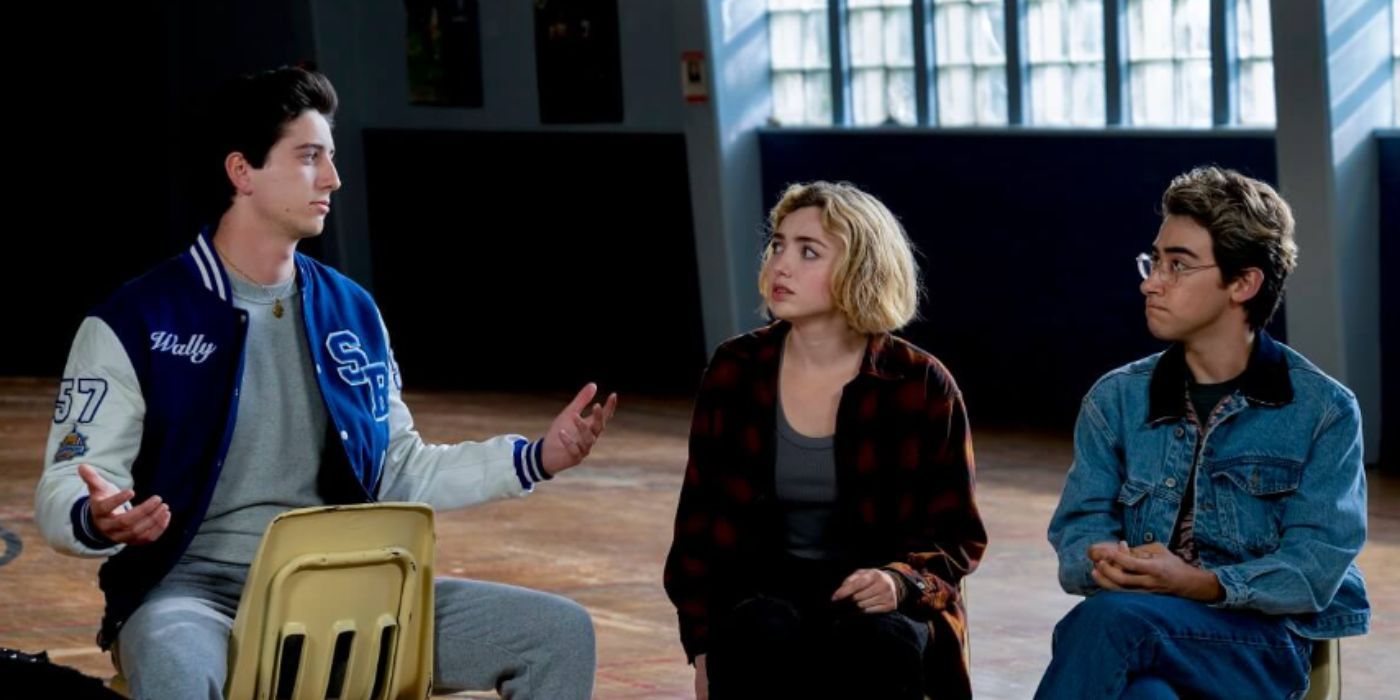 Three students sit in an empty school cafeteria talking in School Spirits